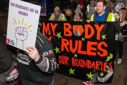 People holding signs at a 'Reclaim the night' march