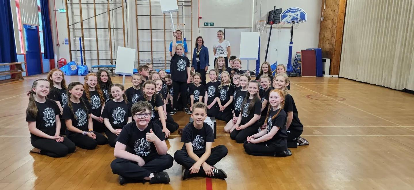 Children from Bridge of Weir Primary School's glee choir, known as Take a BOW, with teachers