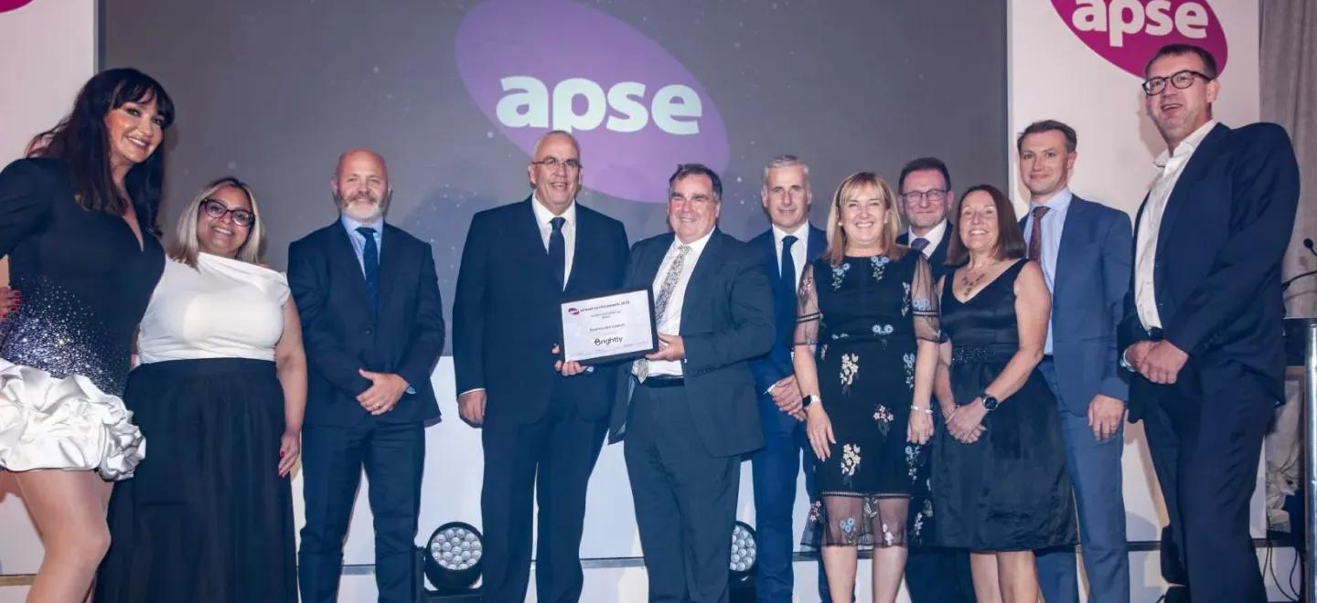 A group of people posing with their award