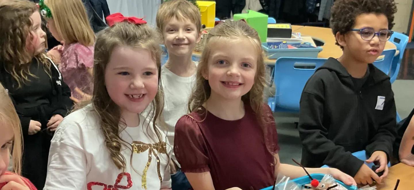 Pupils selling Fairtrade chocolate reindeer packets for Christmas.