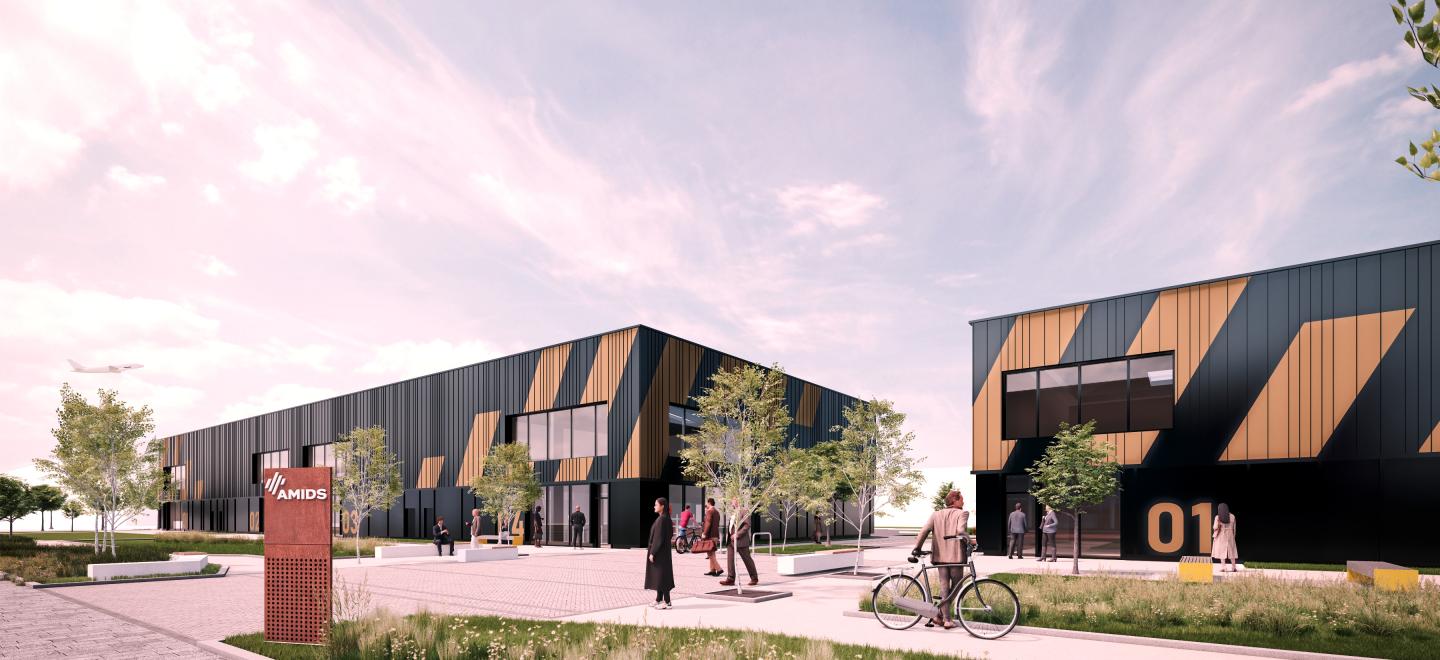 An artist's impression of two buildings named Tech Terrace. They are rectanglular warehouse-type buildings which are pictures as having black and orange markings on the exterior. The picture shows flowerbeds and paths in front of the buildings.