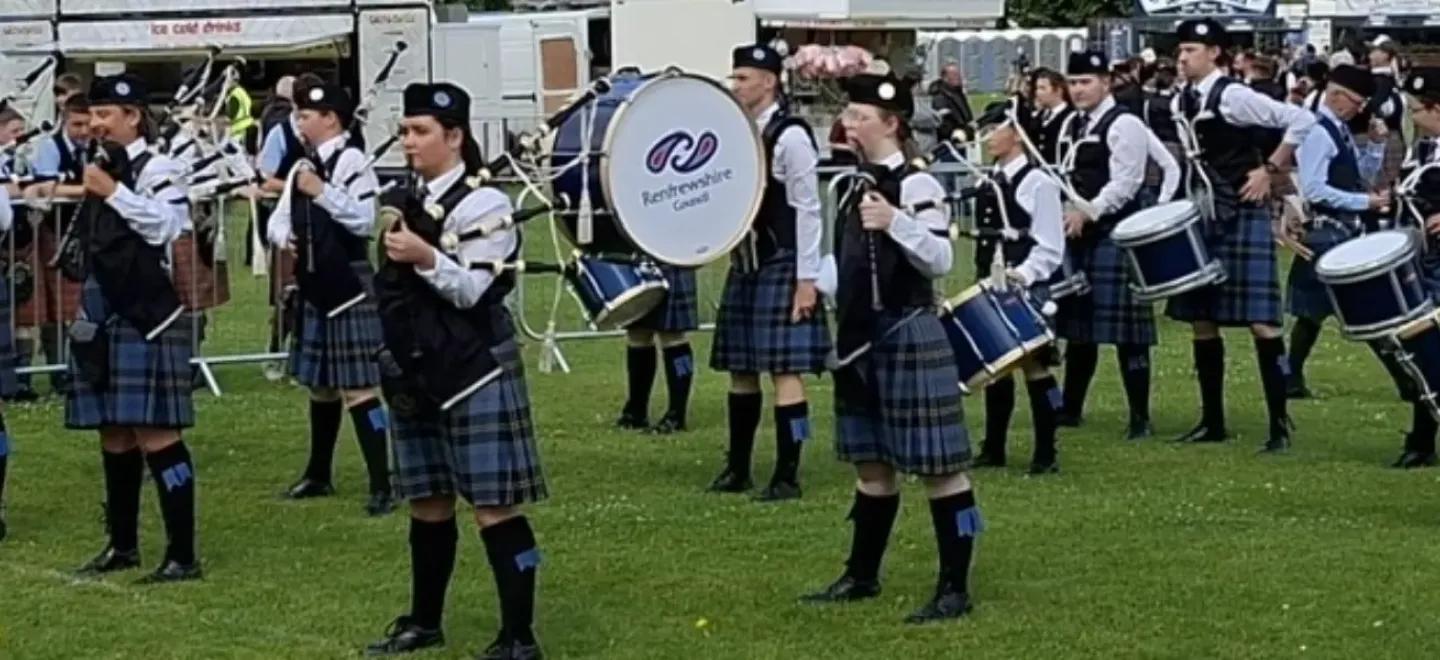 Renfrewshire Schools Pipe Band prepare to play as they stand in formation on a grass field for the European Championships.