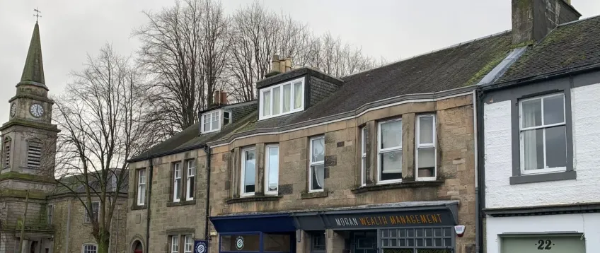 Wide angel view of Lochwinocch high street and church