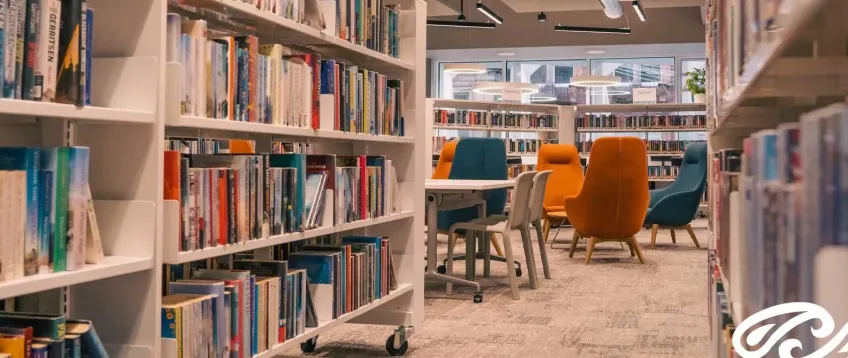 Photo of bookshelves and chairs in Paisley Central Library.