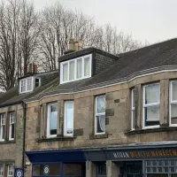 Wide angel view of Lochwinocch high street and church