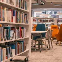 Photo of bookshelves and chairs in Paisley Central Library.