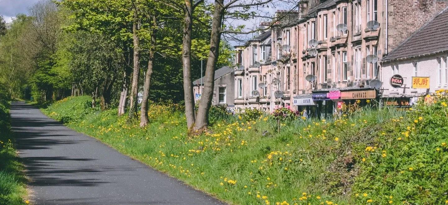 Walking path beside a row of houses in Bridge of Weir.
