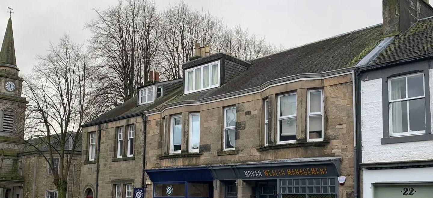 Wide angel view of Lochwinocch high street and church