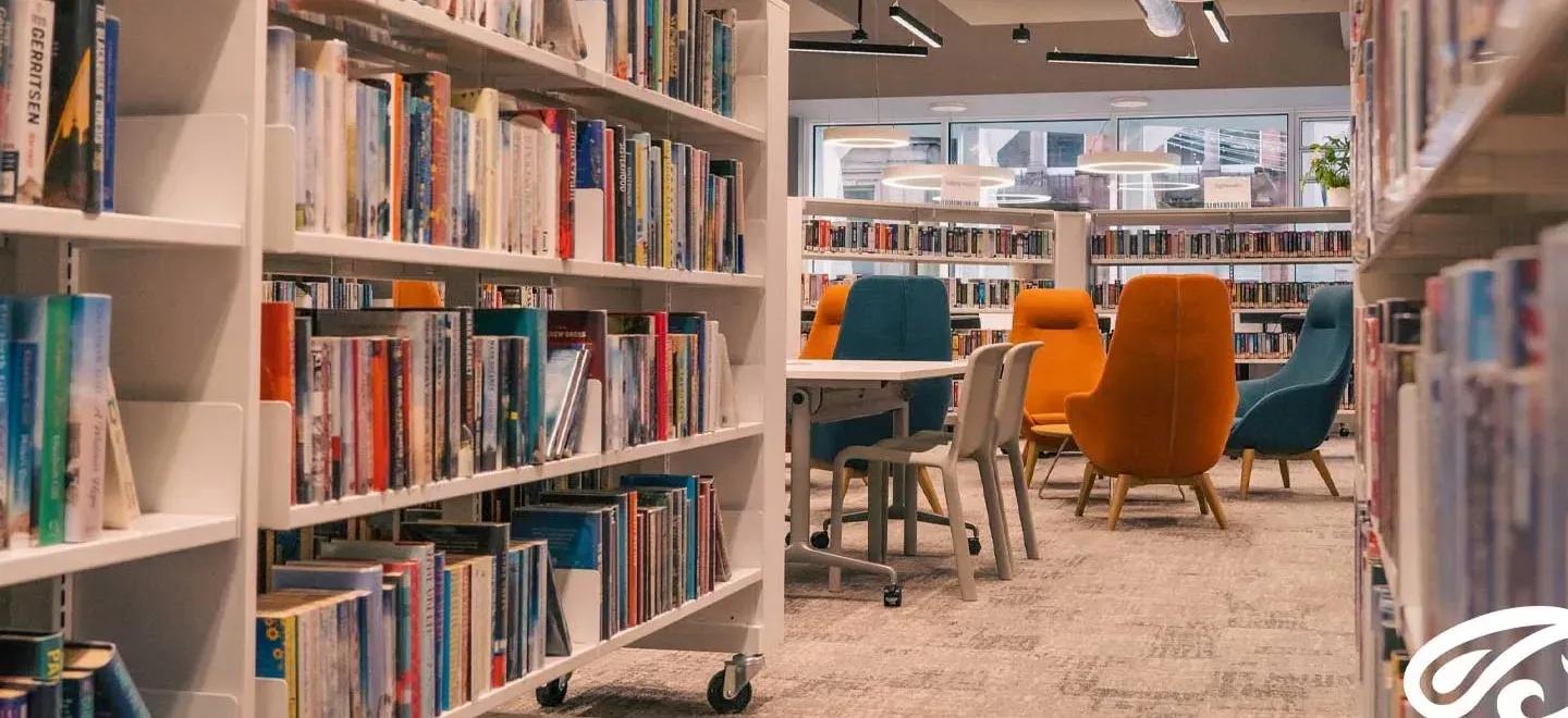 Photo of bookshelves and chairs in Paisley Central Library.